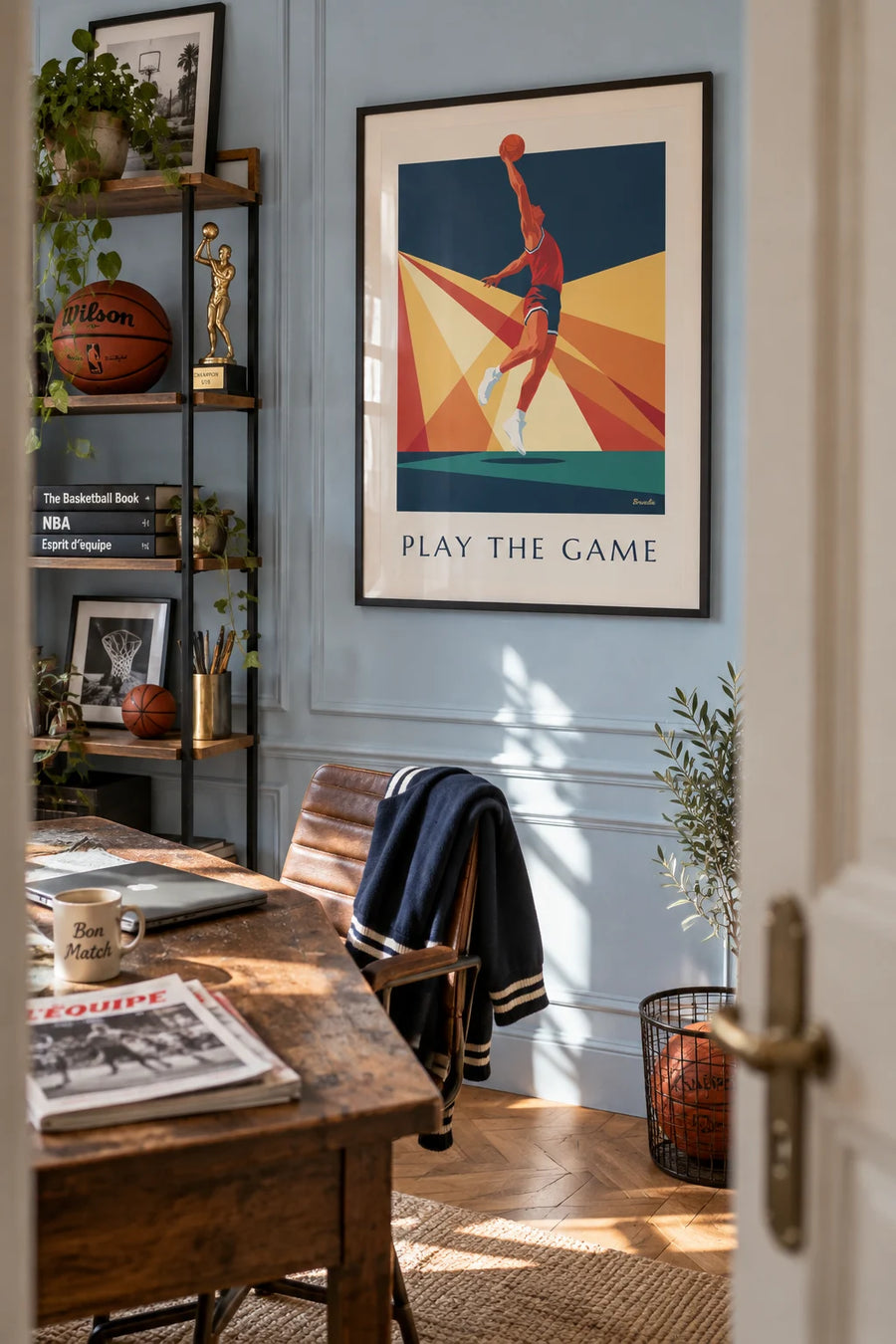 Poster of a basketball player mid-dunk against a backdrop of rays: framed on the wall