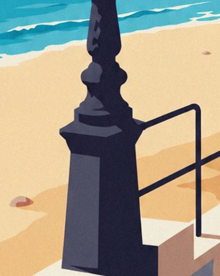 Le pied sculpté d’un réverbère sombre et la rambarde noire devant le sable doré