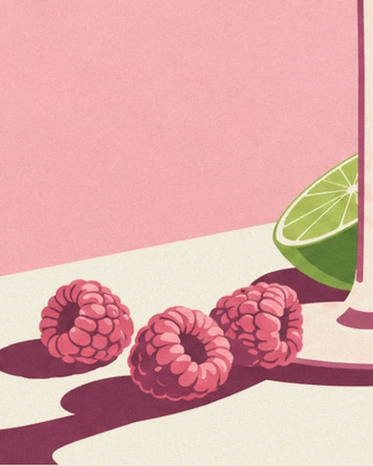 The 3 raspberries and lime half at the base of the glass on the cream table