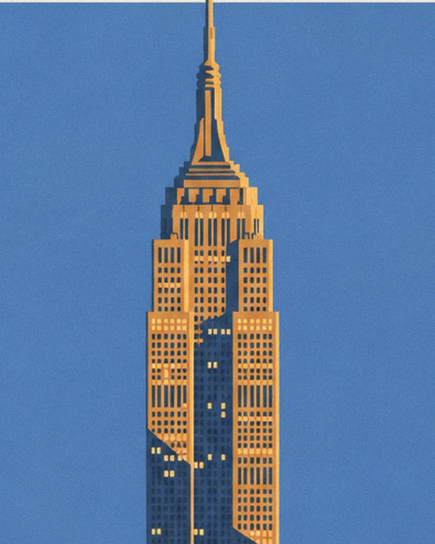 The golden Empire State Building standing out against a blue sky, with its pointed antenna