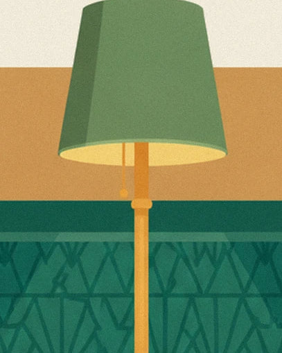 A floor lamp with a golden base and green shade, in front of the living room wall