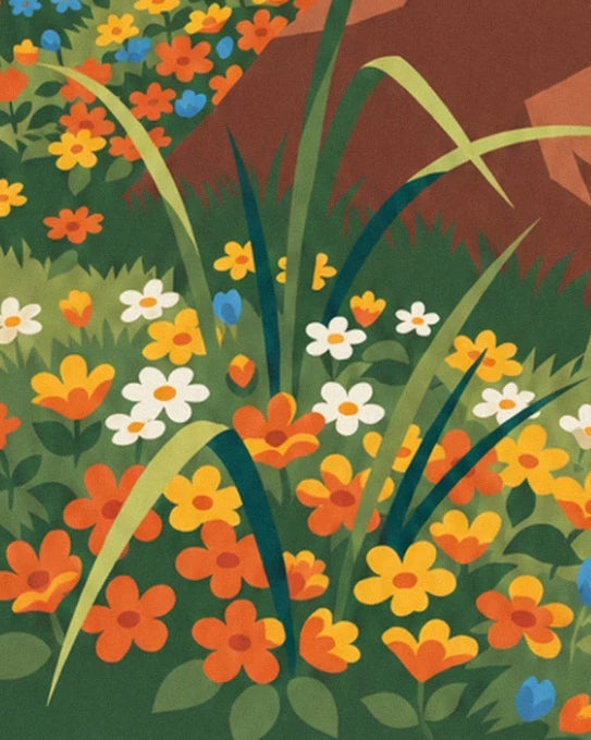 Les fleurs orange, jaunes et blanches parmi les longues herbes au pied du rocher