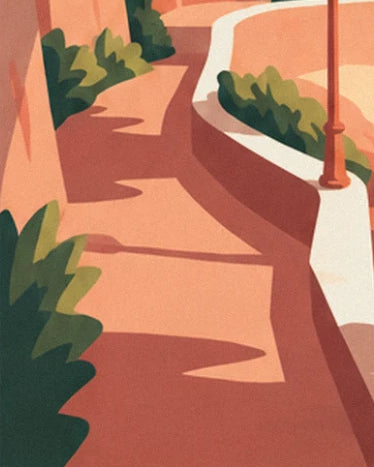 Le chemin ocre aux ombres longues, longé d'un muret blanc, d'un lampadaire rouille et de buissons verts