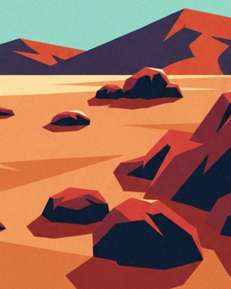 Les rochers rouge sombre sur le sol orangé, devant les montagnes aux ombres bleues