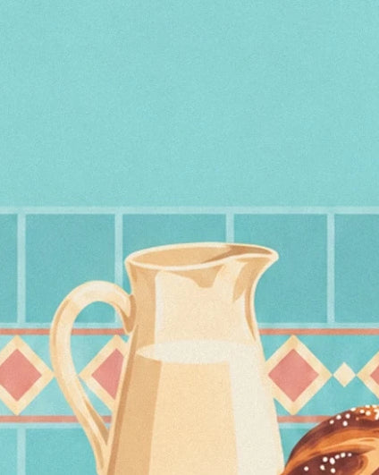 A creamy yellow jug in front of turquoise tiles with a pink diamond border