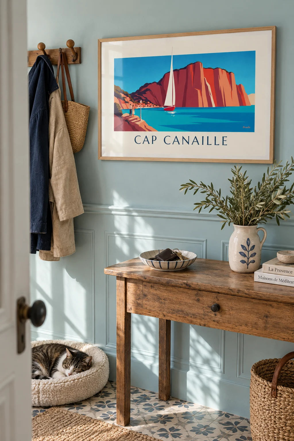 Living room: Sailboat below the red cliffs of Cap Canaille poster on the wall