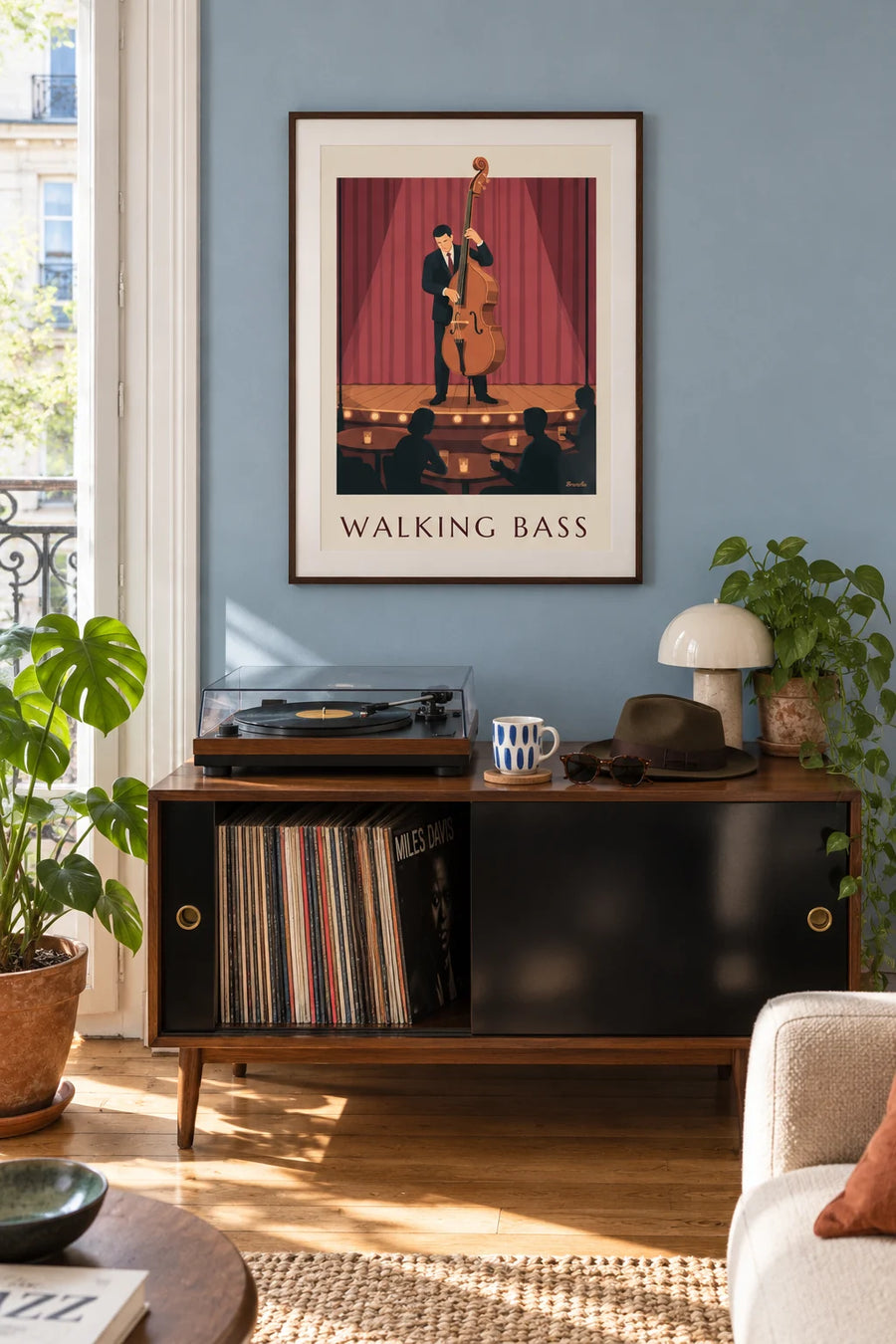 Poster of a jazz double bassist on stage in front of the red curtain: framed on the wall
