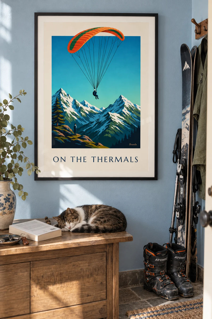 Poster of a paraglider above snow-capped peaks: framed on the wall