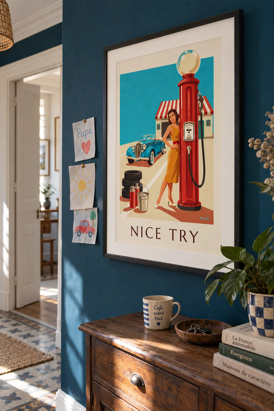 Poster of a winking pin-up and a red gas pump: framed on the wall